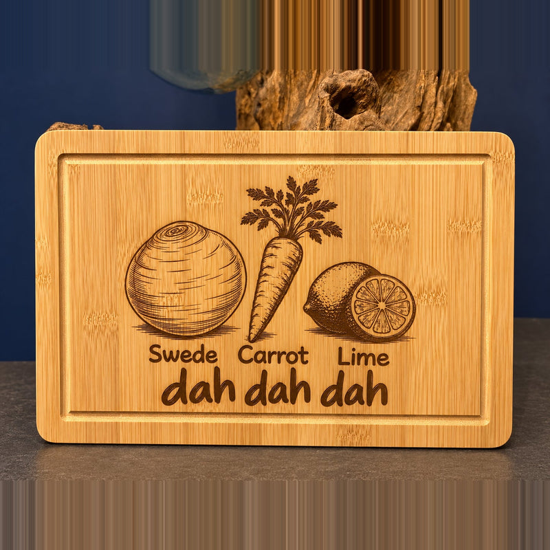 Full engraved swede carrot lime bamboo chopping board, shown entirely on the original dark background